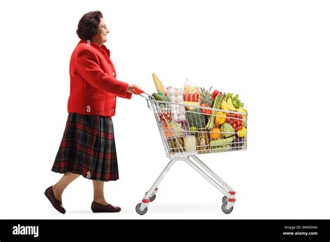 Full Length Profile Shot Of An Elderly Woman Walking With A Shopping