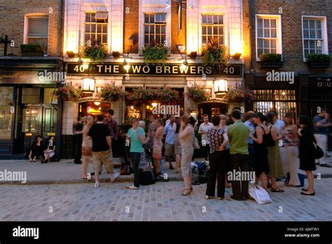 Patrons Drinking Outside The Two Brewers Pub In Covent Garden In London