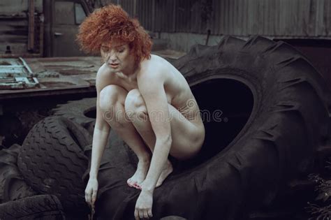 Naked Red Haired Woman Poses Among Old Tires Stock Photo Image Of