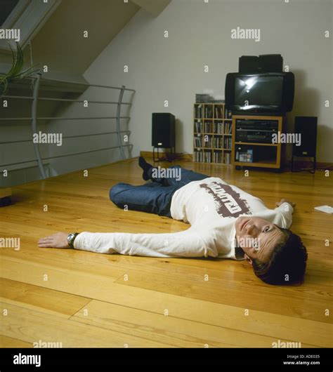 Young Man Lying On Wooden Floor At Home Stock Photo Alamy