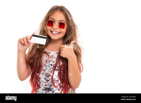 Joyful Girl In Stylish Red Sunglasses Holding Plastic Debit Card And Giving Thumbs Up Gesture