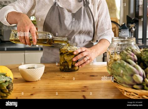 Woman Preparing Canned Italian Artichokes In Olive Oil Artichoke