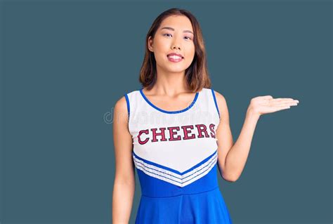 Young Beautiful Chinese Girl Wearing Cheerleader Uniform Smiling