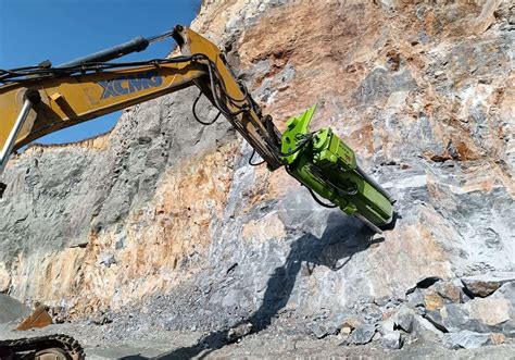 Rock Drill And Splitter Attachments Mounted On Excavators