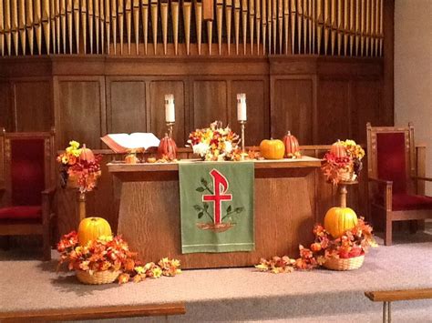 The Altar Is Decorated With Flowers And Pumpkins