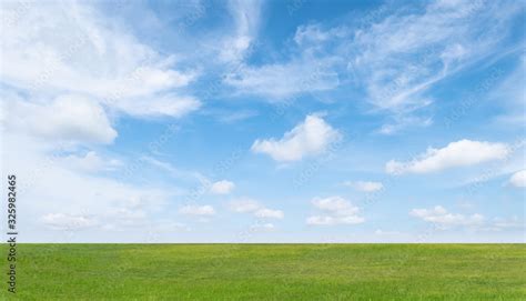 Green grass field and blue sky with white clouds. Beautiful landscape ...