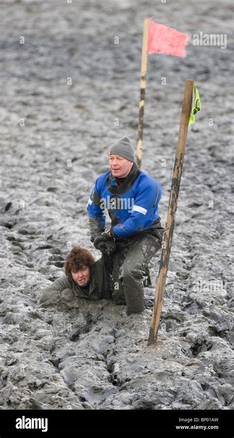 A Competitor is pulled out of the mud during the Maldon Mud Race. Picture by James Boardman ...