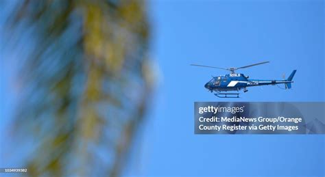 A Long Beach police helicopter keeps an eye on a May Day march in ...