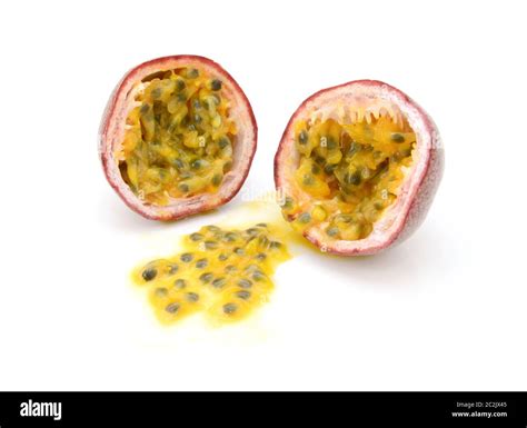 Passion Fruit Cut In Half With Juicy Yellow Pulp And Seeds On A White