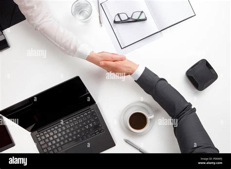 Business People Shaking Hands At Office Desk Stock Photo Alamy