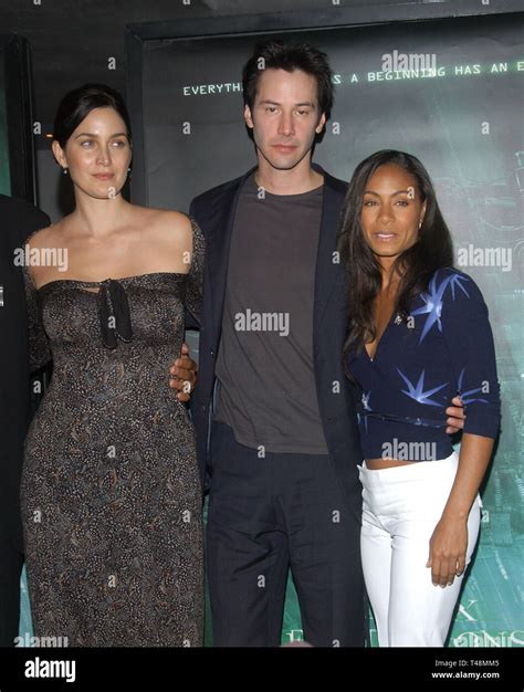 LOS ANGELES, CA. October 27, 2003: Actor KEANU REEVES with actresses CARRIE-ANNE MOSS (left ...