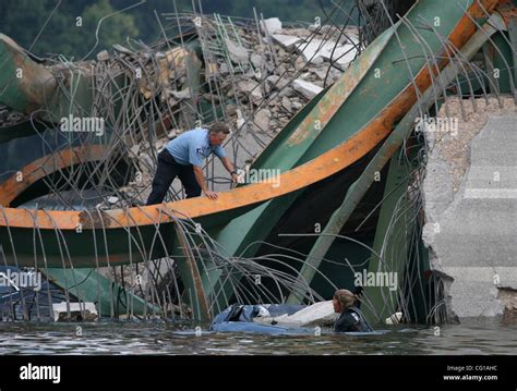 A Firefighter Surfaces After Diving Underwater To Peer Inside A Submerged Car Covered With