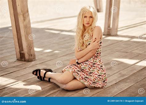 Attractive Blonde Young Woman With Curly Hair Look At Camera Posing