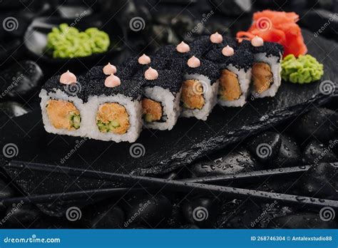California Rolls Covered Black Tobiko on a Black Board Stock Photo ...