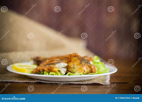 Fried Hake Fish In Batter With Lettuce And Lemon In A Plate Stock Photo