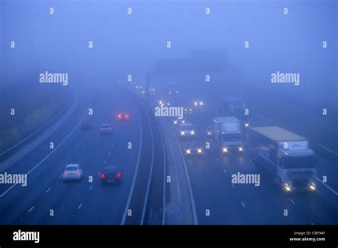 Traffic Travelling On The A M Motorway In Thick Fog Leeds Yorkshire Uk