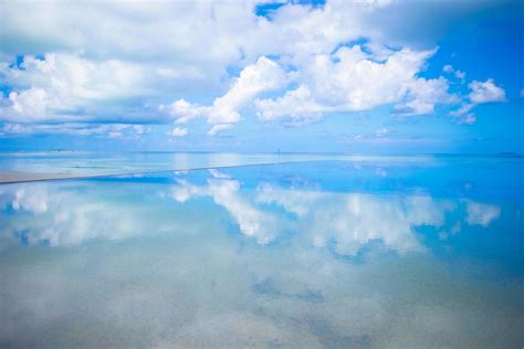 Reflection Of Clouds In Still Water Stock Photo At Vecteezy