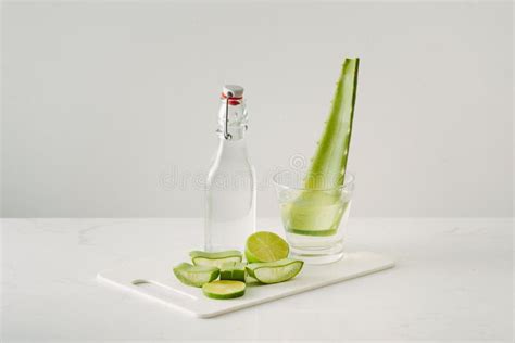 Fresh Aloe Vera Leaves And Aloe Vera Juice In Bottle Glass On White