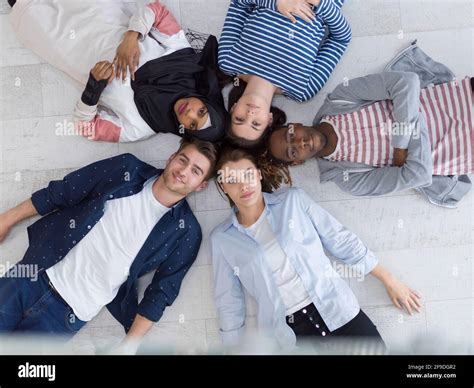 Top View Of A Diverse Group Of People Lying On The Floor And