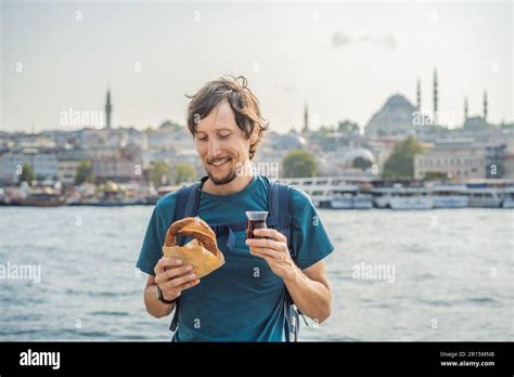 Man In Istanbul Having Breakfast With Simit And A Glass Of Turkish Tea