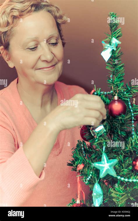 Beautiful Blonde Woman Decorating A Christmas Tree Stock Photo Alamy