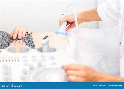 Doctor Scanning Young Pregnant Woman Performing Obstetric Ultras Stock