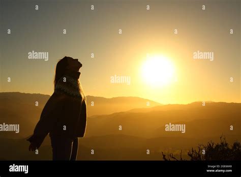 Profile Silhouette Of A Woman Breathing Fresh Air At Sunrise In The