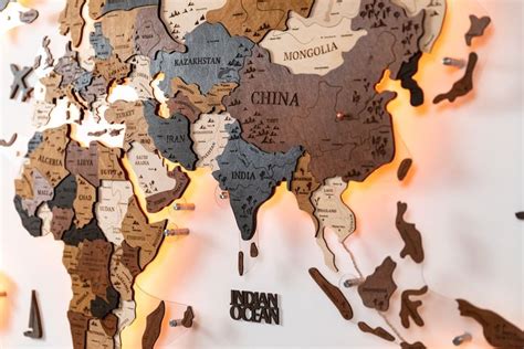 A World Map Made Out Of Wood With The Names Of Countries On Its Sides