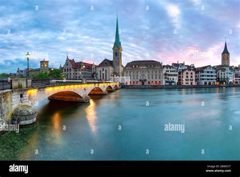 Famous Fraumunster Church And Munsterbrucke Bridge Over River Limmat At