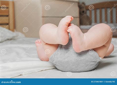 Close Up Legs Of Newborn Baby On Background Of Bedroom Stock Image