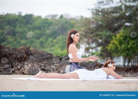 Beautiful Asian Woman Enjoying Spa Massage Therapy On The Beach Stock