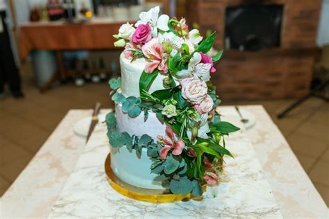 Premium Photo White Wedding Cake Decorated By Flowers Fruits