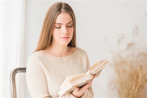 Free Photo Blonde Young Woman Sitting On Chair Reading Book