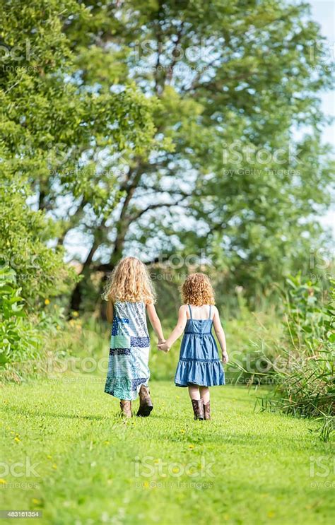 Two Little Sisters Holding Hands