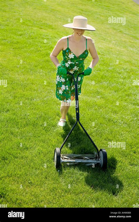 Woman pushing lawn mower Stock Photo - Alamy