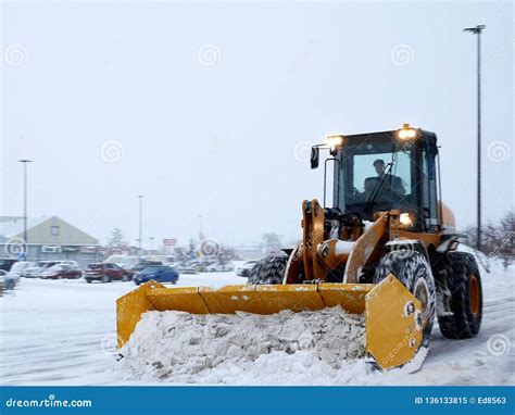 Snow Removal Machine Clearing Parking Lot during Snow Storm Editorial ...