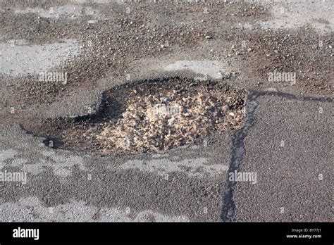 Potholes in the road Stock Photo - Alamy