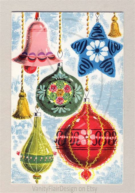 an old christmas card with ornaments hanging from it