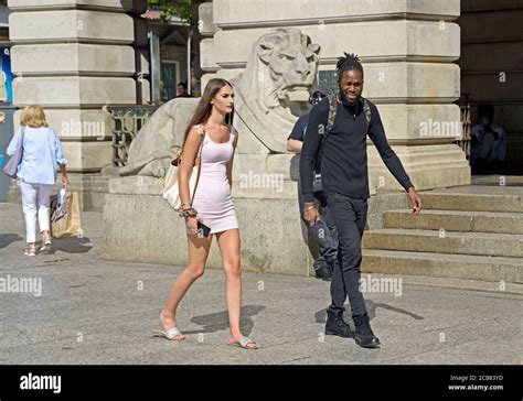 White girl in pink dress, walking with black guy Stock Photo - Alamy