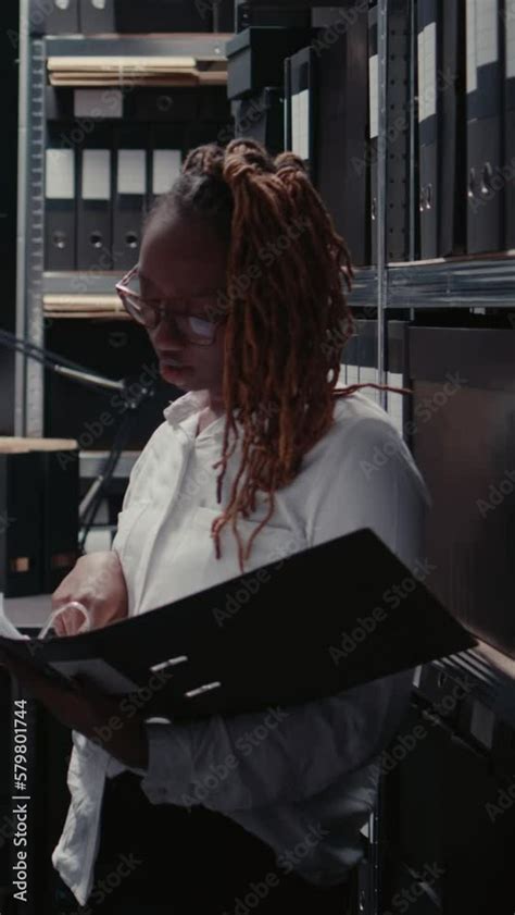 Vertical Video Police Officers Examining Case Files For Clues In