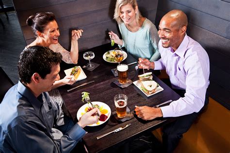 Two Couples Eating In A Restaurant Stock Photo Download Image Now