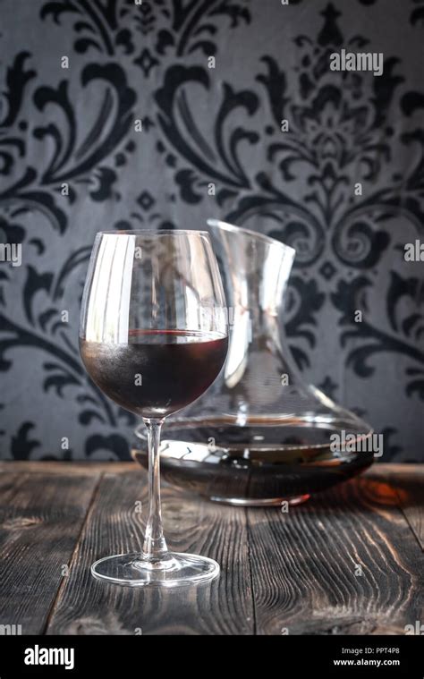 Decanter and glass with red wine Stock Photo - Alamy