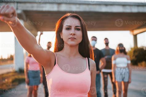 Woman On The Front Of Crowd Group Of Protesting Young People That