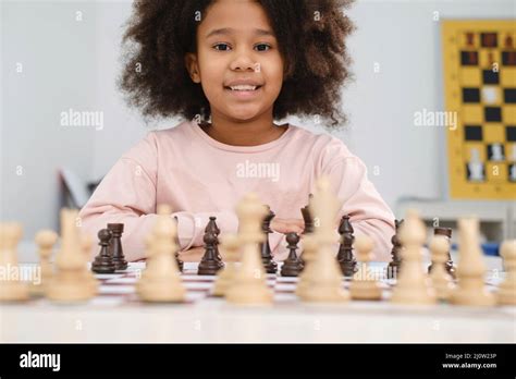 African American girl playing chess. Happy smiling child behind chess ...