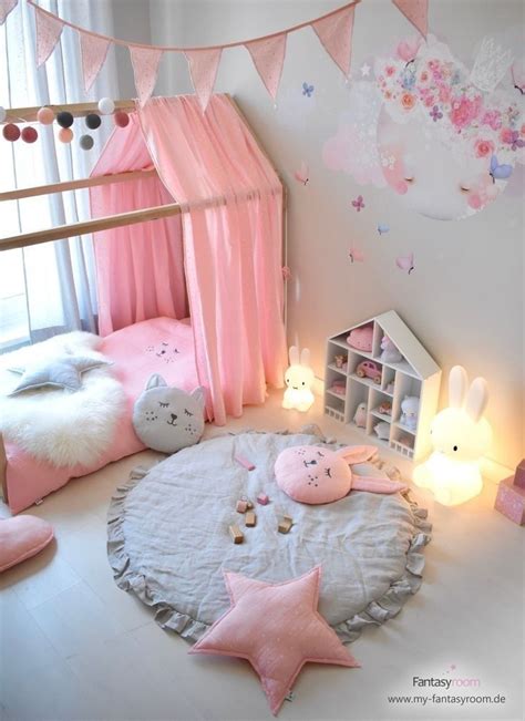 A Bedroom With Pink And White Decor On The Walls Bedding And