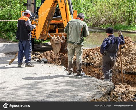 Excavator Three Diggers Dig Trench Lay Drainage Pipe Public Road