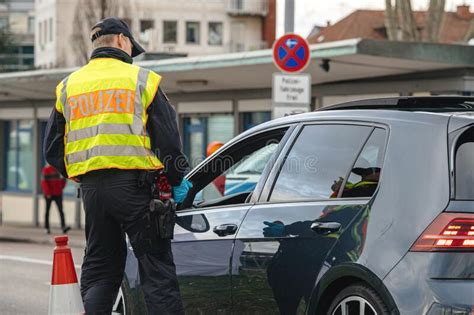 Officer Of The Bundespolizei Checks Traffic At The Border Crossing