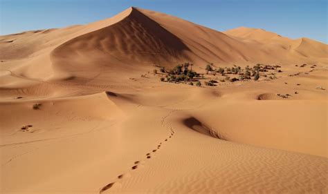 Photographs Of The Sand Dunes Of Erg Chebbi Beneath Merzouga Village In