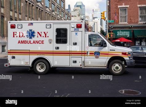 A White Ambulance Fire Department Of New York Parked On The Street In