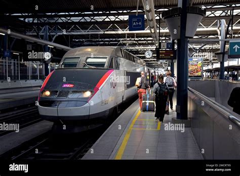 Passengers Getting On A French SNCF TGV Inter City High Speed Train To